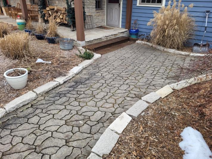 Cracked decorative concrete walkway and entry patio before replacement in Northwest Indiana